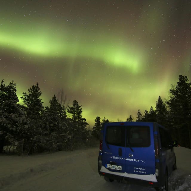Kiruna: Northern Lights Minivan Chase with Warm Drink - Waiting outdoors with a hot drink and Lapland snacks