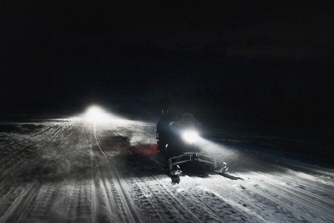 Northern lights safari by snowmobile - Leaving Rovaniemi after dark