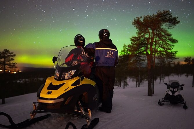 Northern Lights Snowmobile Hunt - Riding through the snowy forest