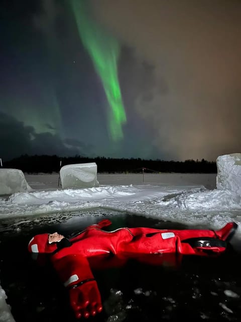 Rovaniemi: Ice Floating Experience with Northern lights - A frozen lake viewed from inside the water