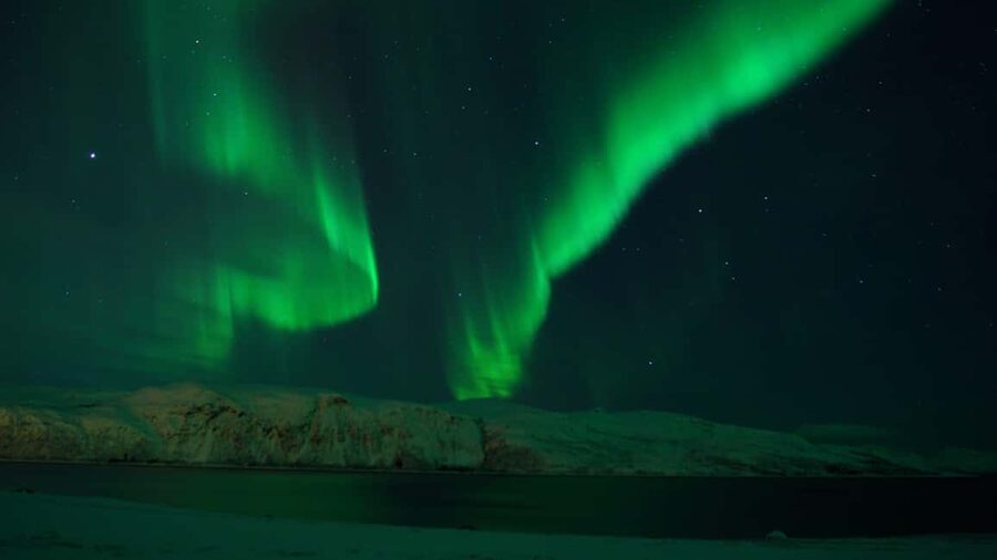 Tromsø: Northern Lights Tour in Glass Minibus with Dinner - The fire, dinner, and a hut by the lake